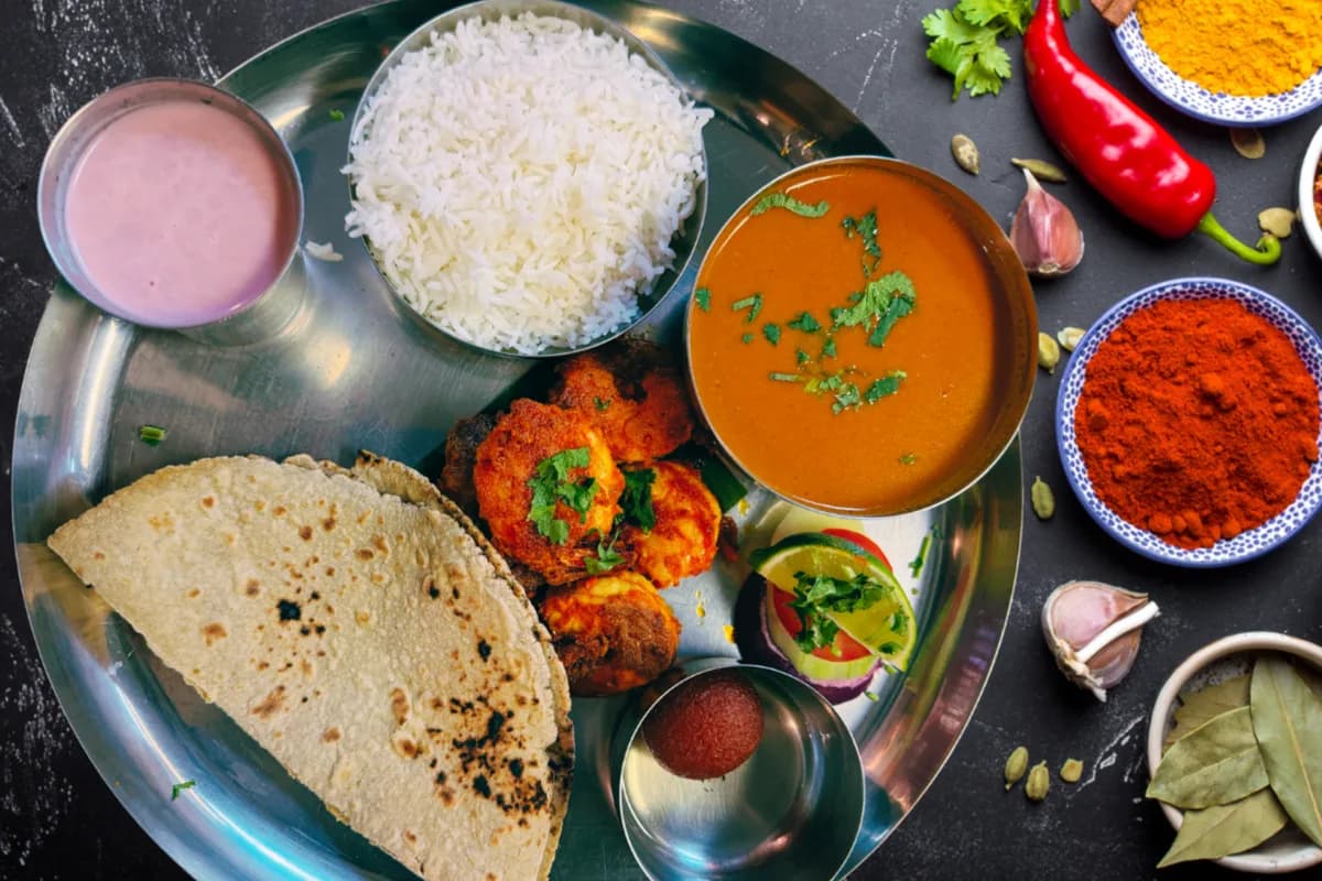 Maharashtrian thali with curry, rice and chapati, the home-style meal in Mejwaani weekly tiffins in Edison NJ